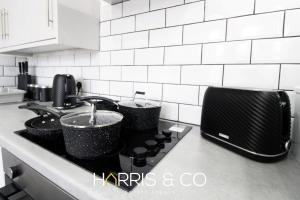 a kitchen counter with two pots on a stove at Roundtree & Berry - Fleetwood in Fleetwood