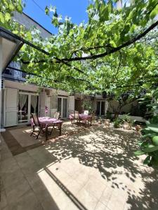 a patio with a table and chairs and trees at Splendid Luxury Apartments in Budva