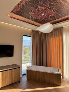 a room with a bath tub and a window at Erta Hotel and Restaurant in Gramsh +27 photos