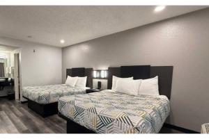 a hotel room with two beds with white pillows at Motel 6-Ely, NV in Ely +27 photos