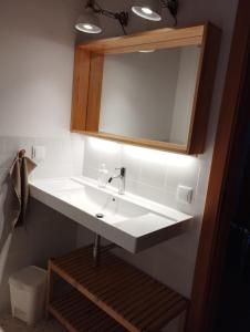 a bathroom with a white sink and a mirror at Endless Summer Surf House in Aljezur