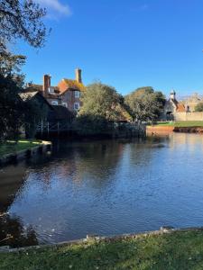 a view of a river with houses in the background at The Roost in Beaulieu