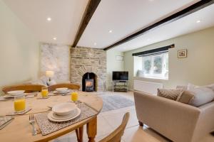 a living room with a table and a fireplace at 3 Ivy Terrace in Bradley