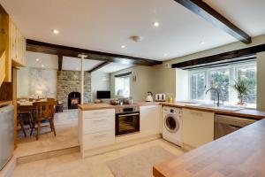 a kitchen with a washer and dryer and a dining room at 3 Ivy Terrace in Bradley