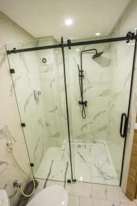 a bathroom with a shower and a toilet at HAGS Apartment - Traditional Modern Apartment, full AC, 10m from airport in Marrakech