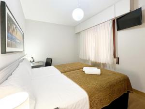 A bed or beds in a room at Pension Berceo