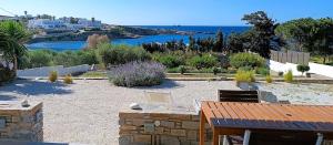 a garden with a view of the ocean and a beach at Nesaea seafront house in Parasporos