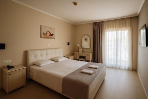 a bedroom with a large bed with two towels on it at Hotel London in Athens
