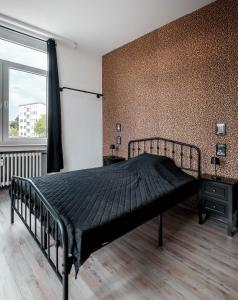a bedroom with a bed with a black comforter at Rock City Apartments Room 5150 in Essen