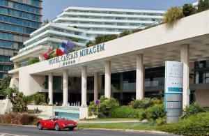 a red car parked in front of a building at Hotel Cascais Miragem Health & Spa in Cascais