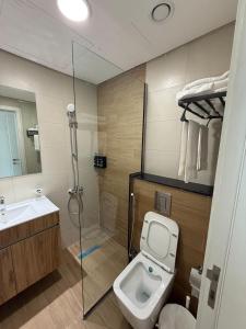 a bathroom with a shower and a toilet and a sink at Furnished 3BR Maryah Vista Near Cleveland by Central Stay in Abu Dhabi