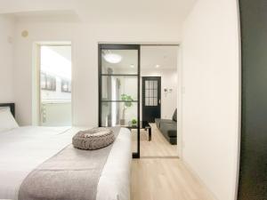 a bedroom with a large bed and a living room at GLITTER202 Max 6ppl 5 minutes to USJ by train in Osaka