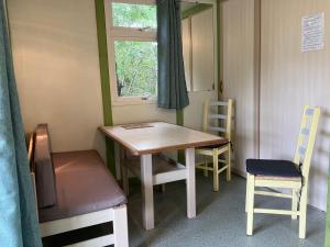 a table and chairs in a room with a window at Espace Shunyata Verdon Silence Nature in La Palud sur Verdon +8 photos
