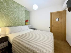 A bed or beds in a room at Pension Berceo