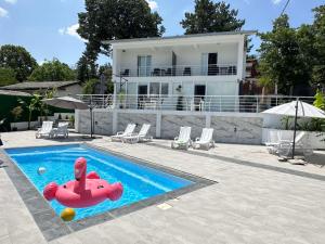 a house with a swimming pool with an inflatablelatable boat at Aqualux Luxury in Star Dojran