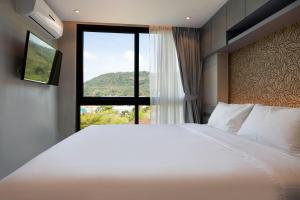 Ένα ή περισσότερα κρεβάτια σε δωμάτιο στο Tropical Kamala Hill View 1 BR CTG P407 +18 φωτογραφίες