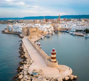 a lighthouse on a dock in a body of water at Reby's House 1 in Monopoli