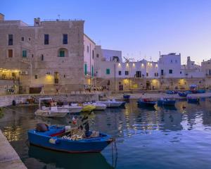 a group of boats in the water in front of buildings at Reby's House 1 in Monopoli