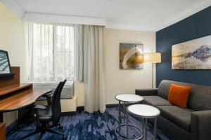 a living room with a couch and a table at Fairfield by Marriott Inn & Suites Herndon Reston in Herndon