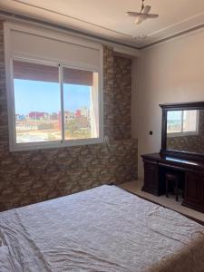 a bedroom with a bed and a piano and a window at 2 Chaaban 1, 1136 in Larache