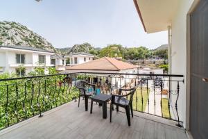 a balcony with chairs and a table on it at Saygın Otel Selimiye in Selimiye
