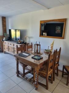 a dining room with a wooden table and chairs at La parenthèse in Marche-en-Famenne