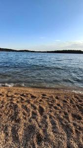 a beach with a body of water and the ocean at Private camp SrimaBAY in Vodice +55 photos