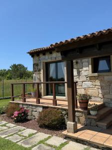 a cabin with a porch and a deck at Villa Atlántica in Ribeira