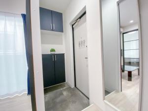 a hallway with a door and a mirror at GLITTER302 Max 6ppl 5 minutes to USJ by train in Osaka +80 photos