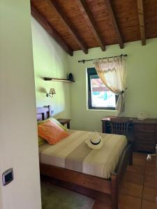 a bedroom with a bed with a hat on it at Villa Atlántica in Ribeira +42 photos