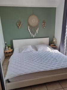 a bedroom with a bed with a white comforter at La parenthèse in Marche-en-Famenne