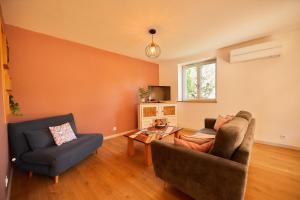 a living room with two chairs and a couch at Chevilyna - cosy - calme-climatisation-jardin-animaux autorisés in Chevigny