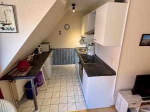 Una pequeña cocina con fregadero y encimera. en Skipper Oog, en Horumersiel