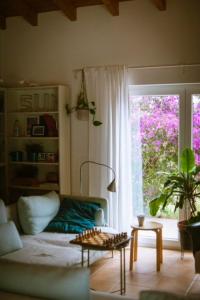 a living room with a couch and a window at Endless Summer Surf House in Aljezur