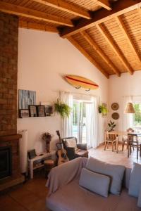 a living room with a surfboard on the wall at Endless Summer Surf House in Aljezur