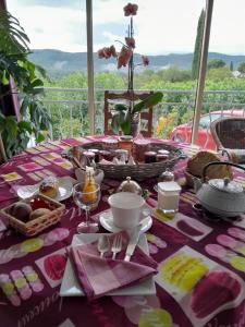 a table with a pink table cloth with food on it at LA GRAND'VIGNE in Chauzon +9 photos