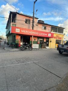 a building on a street with a motorcycle parked in front at Um quarto completo in João Pessoa