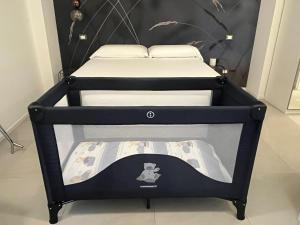 a black bunk bed with two mattresses on it at Residence TRE LEONI in Caorle