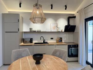 a kitchen with a table and chairs and a refrigerator at 3Liebenauer Boutique Apartments in Worms