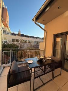 a balcony with a table and chairs on a balcony at 3Liebenauer Boutique Apartments in Worms