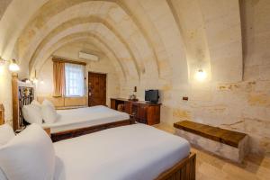 TV a/nebo společenská místnost v ubytování MDC Cave Hotel