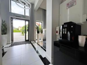 a lobby with a door to a building with a microwave at Villa Nova in Białystok +38 photos