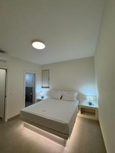 a bedroom with a large white bed in a room at Sohoro Villas in Koufonisia