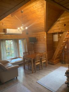 a dining room with a table and chairs in a cabin at Lomahyppäys in Naantali