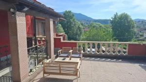a balcony with two benches on a building at The Happy Goat Apartment in Germignaga
