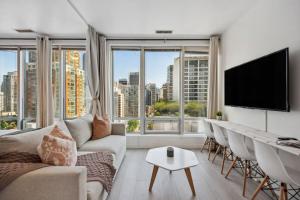 a living room with a couch and chairs and a large window at Cityview Suite near Robson Square and Canada Place for 6 Guests in Vancouver