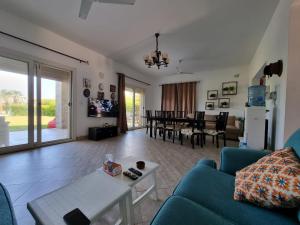 a living room with a blue couch and a table at فيلا فاخرة بتصميم أنيق in El Alamein