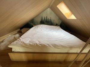a bed in the corner of a room at The Landscape Barn Homes in Râşnov