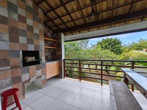 Il comprend un salon avec une cheminée et un balcon. dans l'établissement Reserva Imbassaí Apartamento 1 quarto área de churrasco Bl2202, à Mata de São João