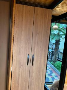a wooden cabinet in a room with a window at SEA Side-მზის მხარე- N 1 in Makhinjauri +41 photos